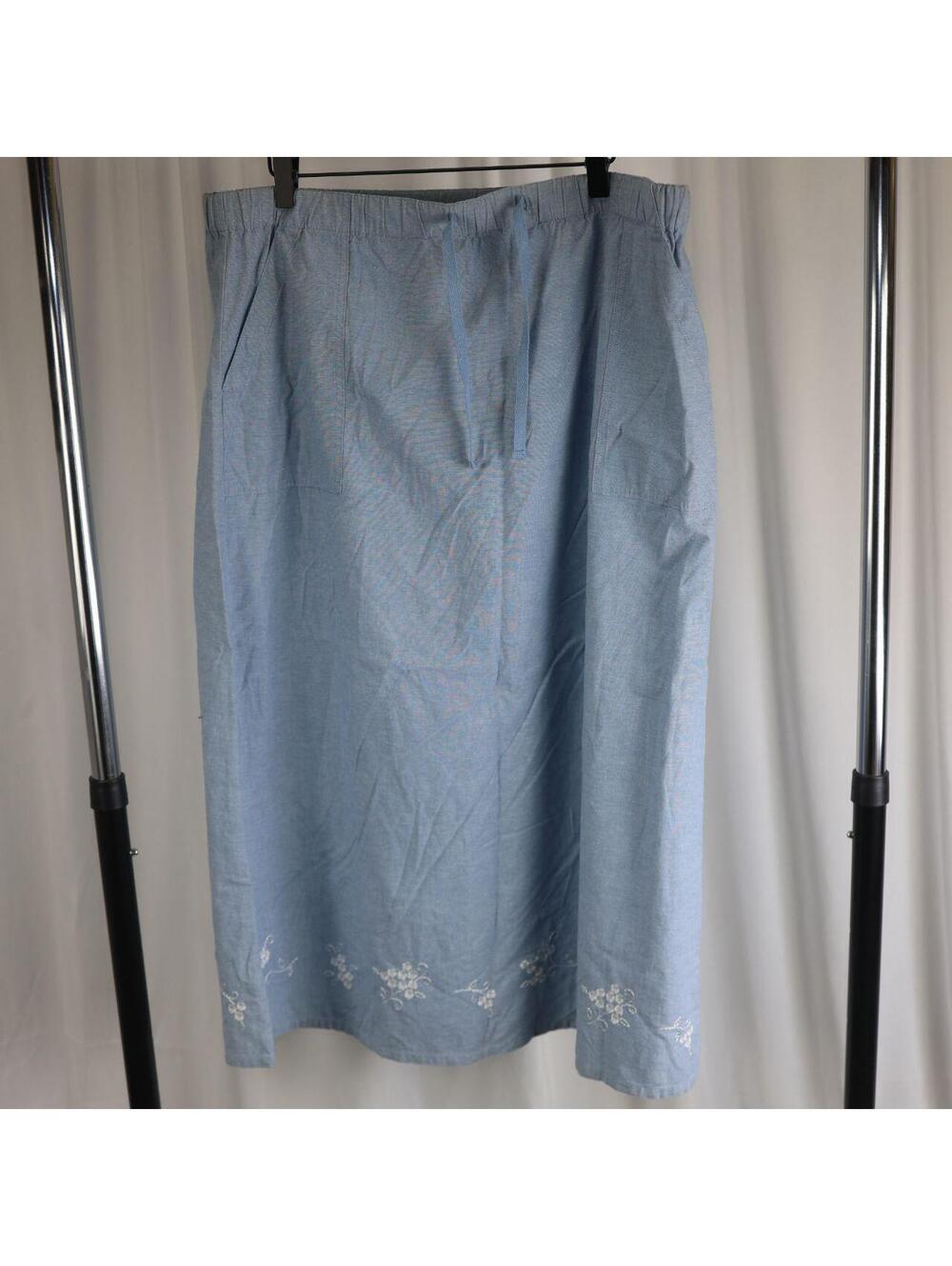 Classic Elements chambray midi skirt in light blue with white floral embroidery.